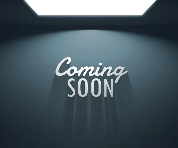 Coming soon text under illuminated ceiling light.