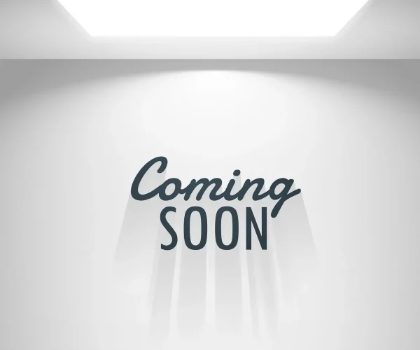Illuminated 'Coming Soon' sign on white wall